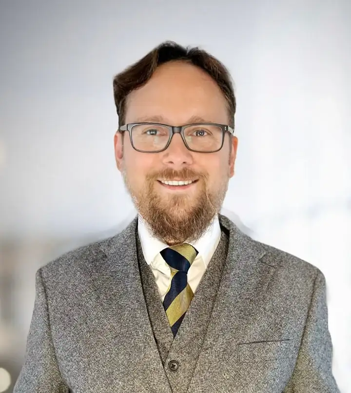 Andrey Lebedev wearing a grey suit and striped tie